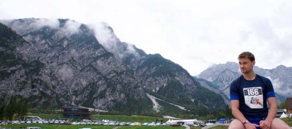 Life coach Richard Harris sitting in front of dramatic mountains